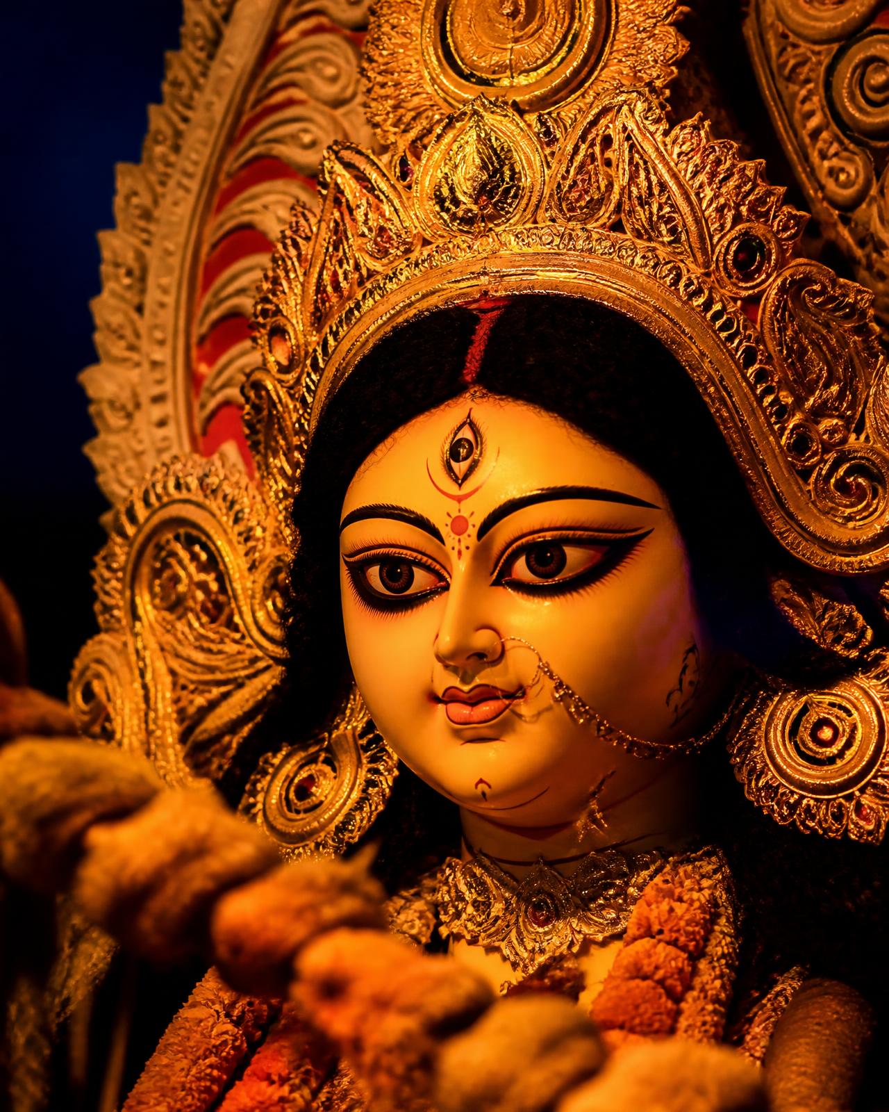 Durga idol lit by lamplight in a Kumartuli workshop