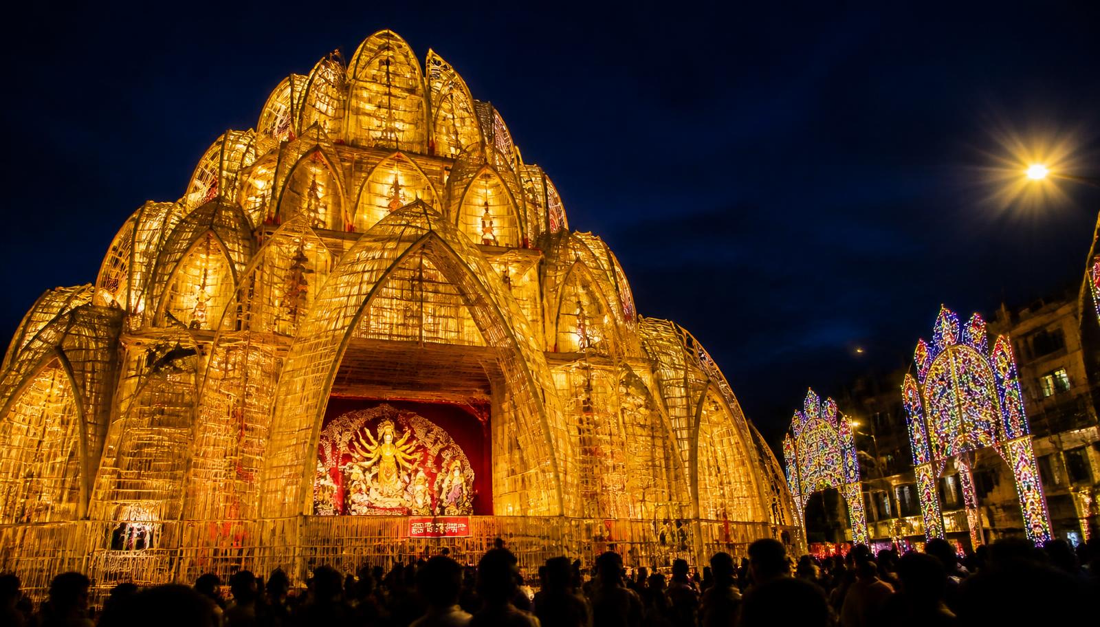 An illuminated Durga Puja pandal at night
